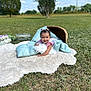 baby, child, outdoor, grass, sky, clouds, pillow, rug, basket, flower, smiling, happy, nature, portrait, infant, greenery, daylight, cute, playful, headband