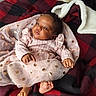 baby, infant, pink_dress, tulle, gold_spots, curly_hair, blanket, checkered, red, black, feet, hands, face, portrait, cute, child, cozy, indoor, soft_light, resting