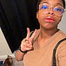 Yoda joined the competition — help win amazing prizes! person, selfie, glasses, peace_sign, cat, indoor, brown_shirt, black_curtain, wooden_floor, short_hair, lip_gloss, watch, ring, casual, home, pet, animal, floor, walking, background
