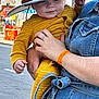 Lucas joined the competition — help win amazing prizes! baby, child, hat, yellow_clothing, striped_clothing, denim, adult, hand, ring, street, road_sign, traffic_cones, urban, outdoor, person, holding, curious, face, blue_eyes, close_up