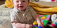 Lucas is registered to the contest to win money with this photo: baby, child, smiling, toy, colorful, carpet, cushion, indoor, homedecor, furniture, blanket, wood, basket, plush, person, happy, cute, face, sitting, infant