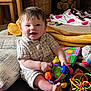 baby, child, smiling, toy, colorful, carpet, cushion, indoor, homedecor, furniture, blanket, wood, basket, plush, person, happy, cute, face, sitting, infant