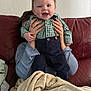 Lucas joined the competition — help win amazing prizes! baby, child, smiling, happy, person, couch, blanket, indoor, clothing, shirt, pants, hands, face, leather, furniture, phone, technology, portrait, cute, holding