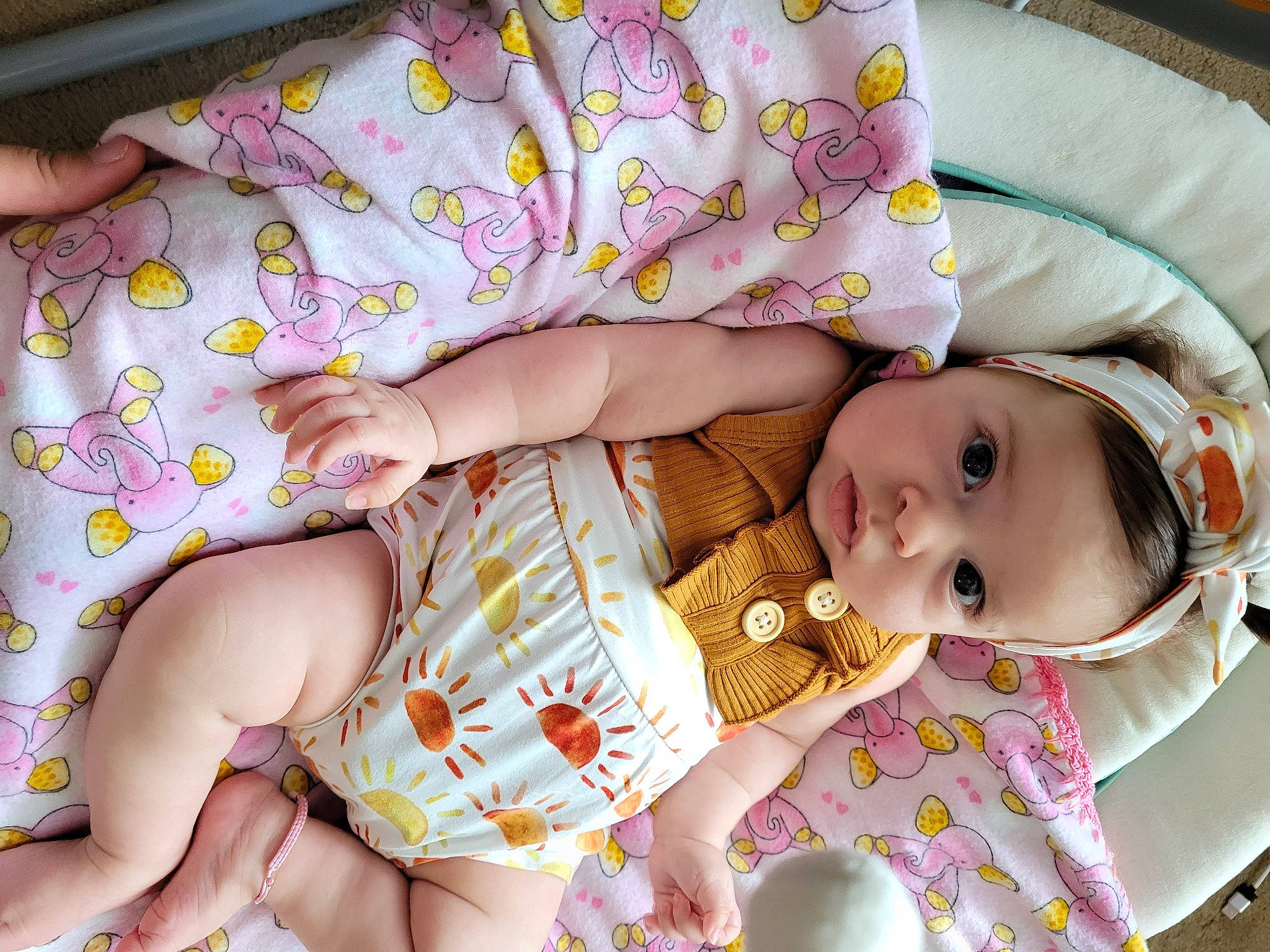 Lily is registered to the contest to win money with this photo: baby, baby_products, baby_toddler_clothing, cheek, child, comfort, eye, happy, head, human_body, human_leg, mouth, nail, pattern, person, pink, skin, sleeve, textile, thigh