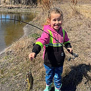 Ellie joined the competition — help win amazing prizes! blue_sky, boots, catch, child, daytime, fish, fishing_rod, girl, grass, happy, hoodie, nature, outdoor, pond, recreational_fishing, smiling, sunny, trees, water, young_person