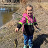 blue_sky, boots, catch, child, daytime, fish, fishing_rod, girl, grass, happy, hoodie, nature, outdoor, pond, recreational_fishing, smiling, sunny, trees, water, young_person