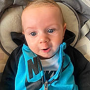 Thiago a rejoint le concours — aidez-le/la à gagner de superbes lots ! baby, black, blanket, blue, child, clothing, cushion, cute, expression, eyes, face, hoodie, indoor, infant, nike, person, portrait, sitting, young, zipper