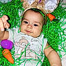 Sylis joined the competition — help win amazing prizes! baby, bunny_ears, carrot_toy, cartoon_print, child, cute, easter_grass, face, green, headwear, holiday_theme, infant, lying_down, orange, outstretched_hand, playful, purple, purple_egg, soft_toys, white_clothing