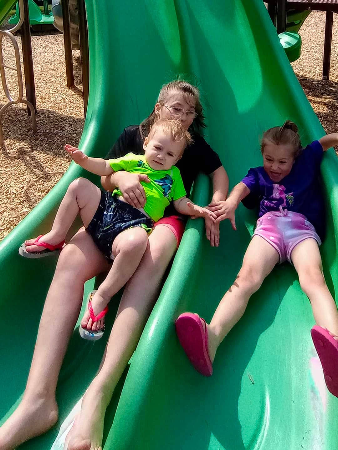 Oliver is registered to the contest to win money with this photo: baby_toddler_clothing, child, chute, city, fun, grass, green, happy, human_body, human_leg, lap, leisure, outdoor_play_equipment, person, photograph, playground, recreation, shorts, sitting, thigh