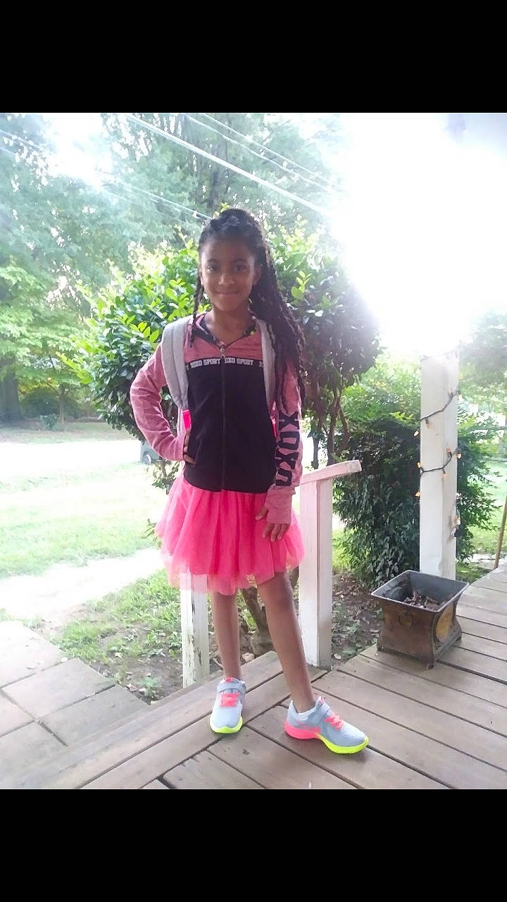 Symara is registered to the contest to win money with this photo: beauty, child, clothing, day, design, dress, fun, girl, joy, leg, pattern, person, pink, play, shoe, shoulder, smile, snapshot, standing, summer