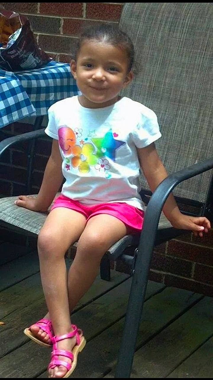 Sienna is registered to the contest to win money with this photo: abdomen, arm, child, clothing, cool, day, fun, girl, hairstyle, hand, human_body, leg, person, pink, play, product, shoulder, sitting, thigh, toddler