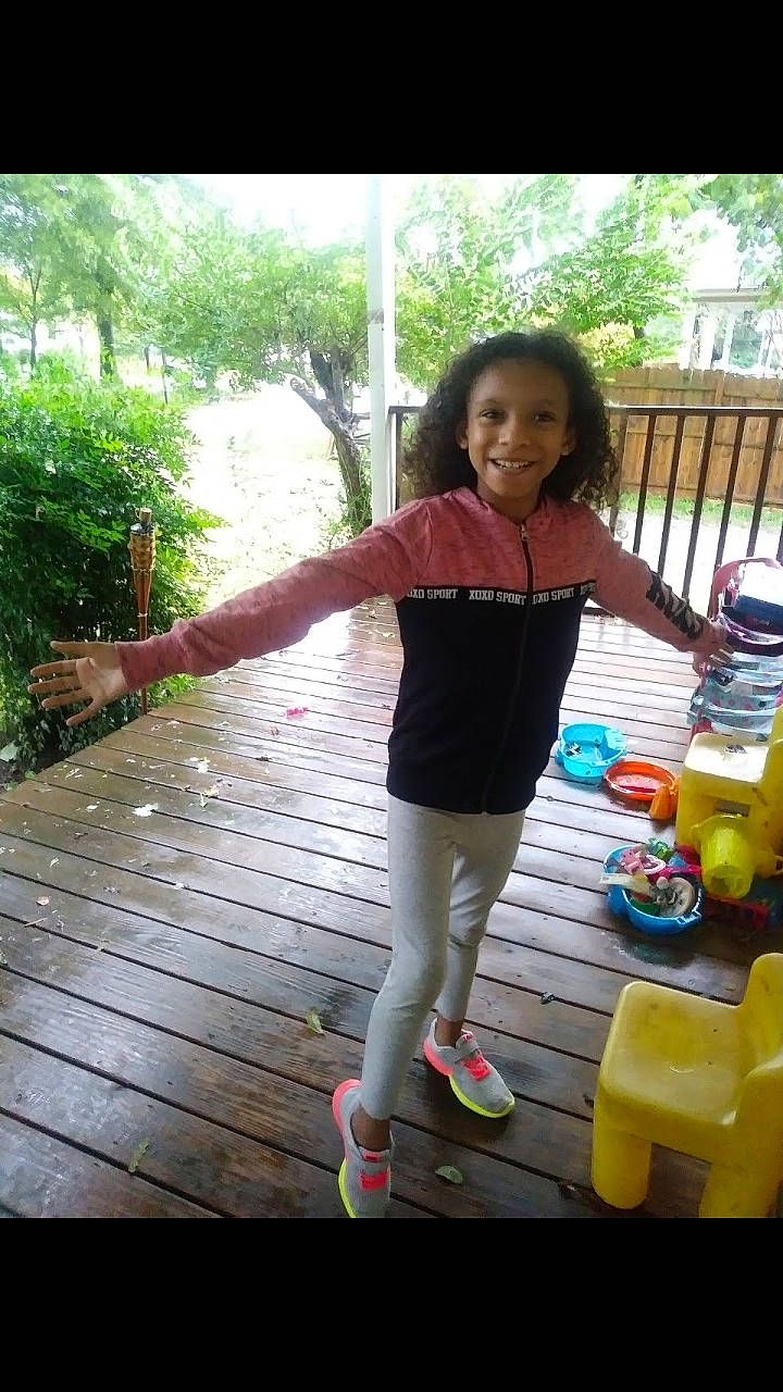 Saniyah joined the competition — help win amazing prizes! arm, child, clothing, day, facial_expression, fun, girl, green, human_body, joy, leg, leisure, person, plant, play, snapshot, standing, summer, toddler, tree