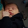 Estella is registered to the contest to win money with this photo: baby, sleeping, infant, newborn, face, hand, clothing, black_sleeve, pacifier, indoor, bedroom, blanket, resting, peaceful, closeup, child, person, soft_light, portrait, sleep