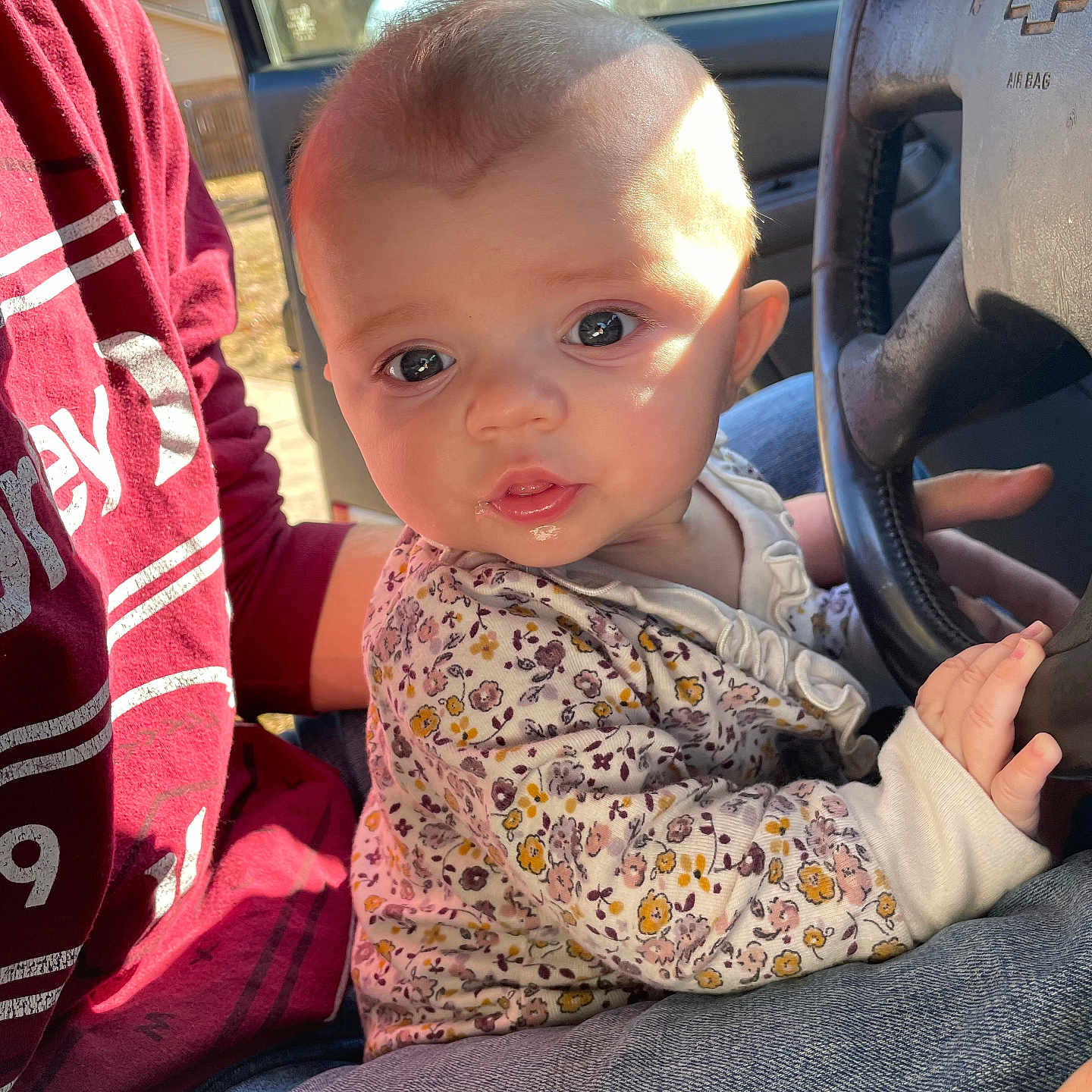 Elsie is registered to the contest to win money with this photo: alloywheel, baby, bodypart, car, carwheel, clothing, cushion, face, finger, hand, head, homedecor, machine, pants, person, photography, portrait, sitting, transportation, vehicle