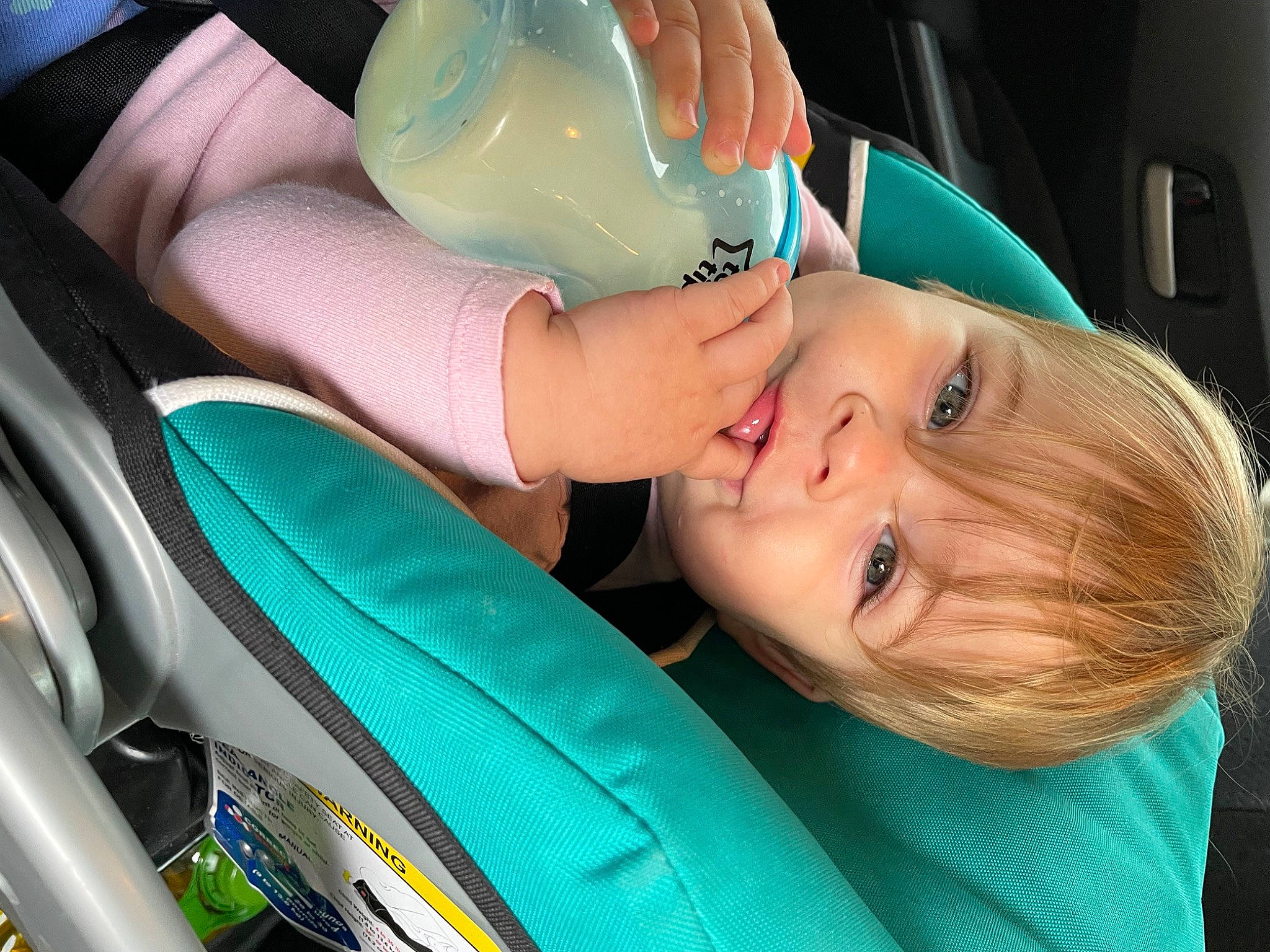 Florence is registered to the contest to win money with this photo: auto_part, automotive_design, automotive_lighting, baby, baby_in_car_seat, car_seat, child, electric_blue, eyelash, fun, green, happy, human_body, person, plastic_bottle, product, seat_belt, skin, steering_wheel, toddler