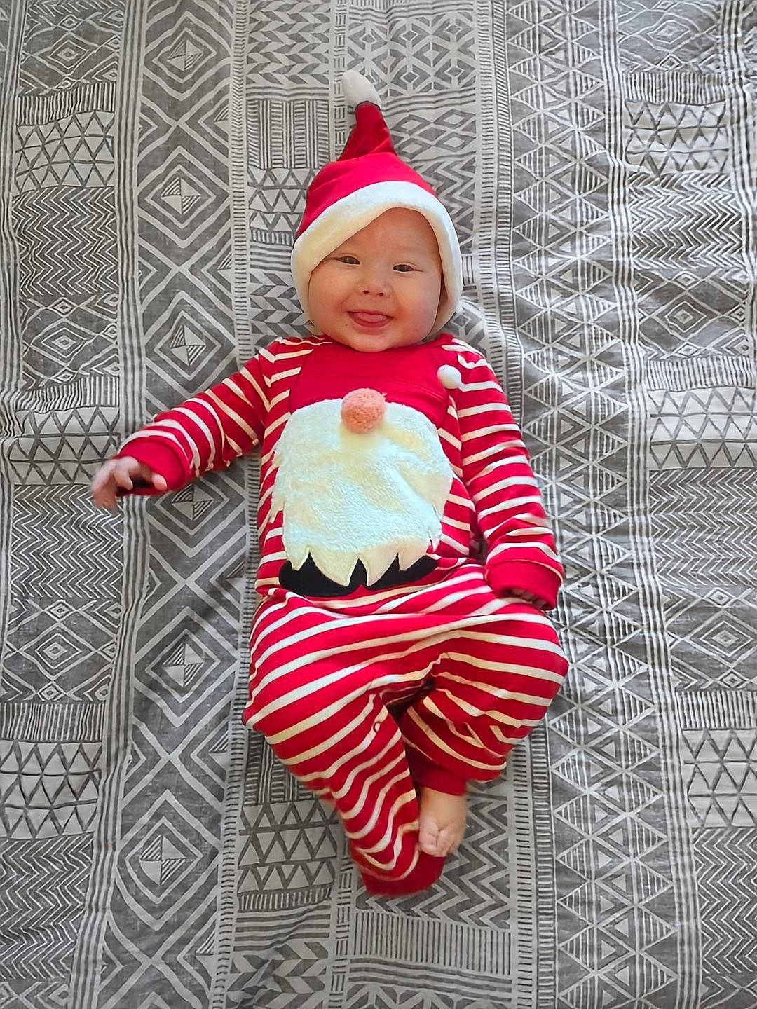 Kasen joined the competition — help win amazing prizes! baby, baby_toddler_clothing, cap, carmine, costume_hat, fictional_character, flooring, happy, headgear, headwear, human_body, joy, linens, outerwear, pattern, person, red, santa_claus, sleeve, smile