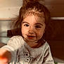 Meilya participe au concours pour gagner de l'argent avec cette photo : bedroom, big_eyes, candid, casual, child, close_up, cozy_clothing, cute, face, hair_bun, happy, indoor, portrait, reaching_hand, shelf, smiling, soft_lighting, sweatshirt, toddler, warm_tone