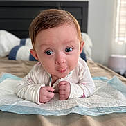 Hiraya Wynne is registered to the contest to win money with this photo: baby, bed, bedding, bedroom, blanket, child, close_up, daylight, eyes, face, hands, indoor, infant, long_sleeves, lying_down, portrait, pouting, tummy_time, white_clothing, wide_eyed