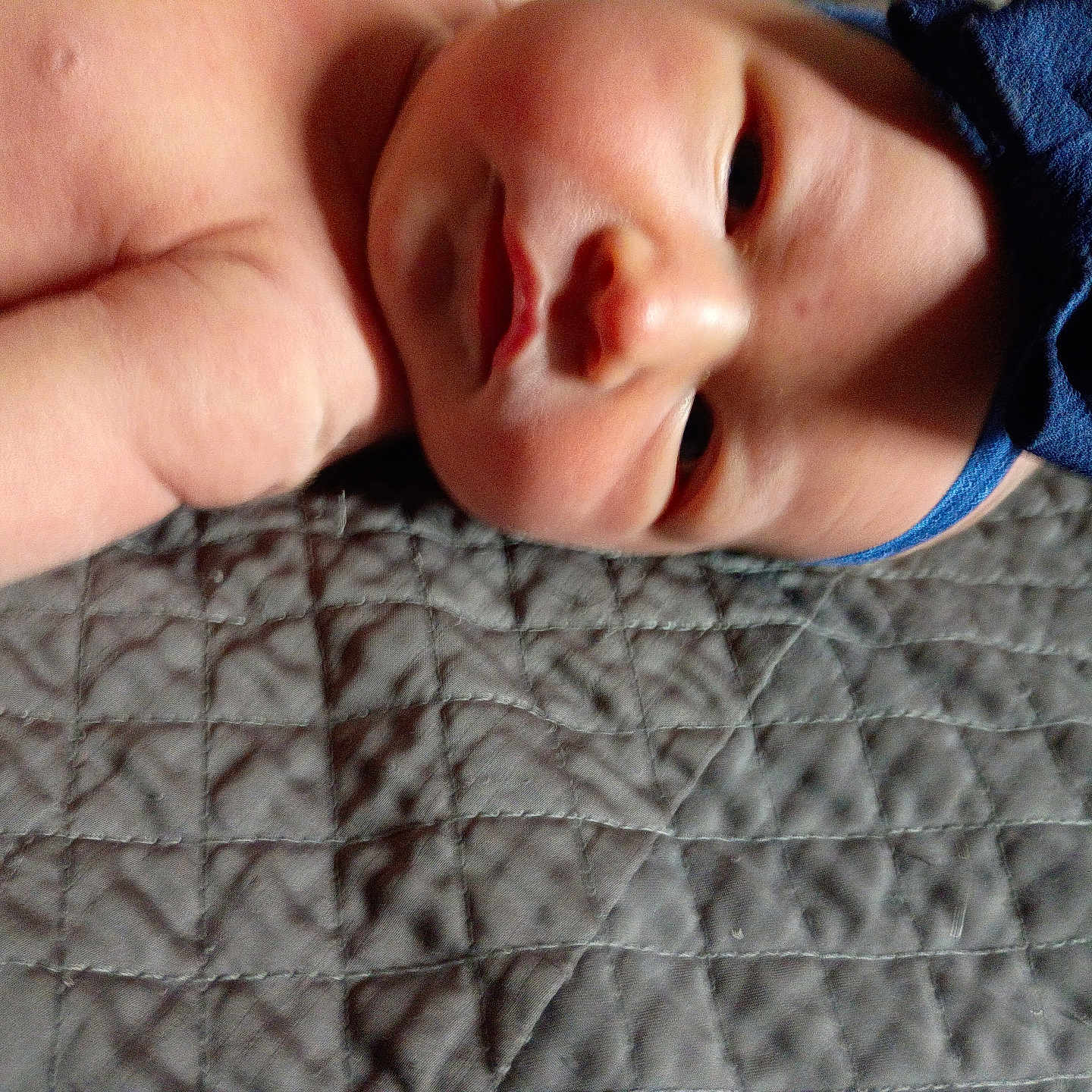 Italy joined the competition — help win amazing prizes! baby, infant, headband, blue, bow, quilt, gray, texture, skin, face, closeup, lying_down, child, newborn, soft_light, portrait, cute, resting, indoors, person