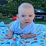 baby, blanket, clothing, cute, daylight, expression, face, fruit_pattern, garden, grass, greenery, hands, infant, lawn_chair, nature, outdoor, pacifier, person, portrait, toddler