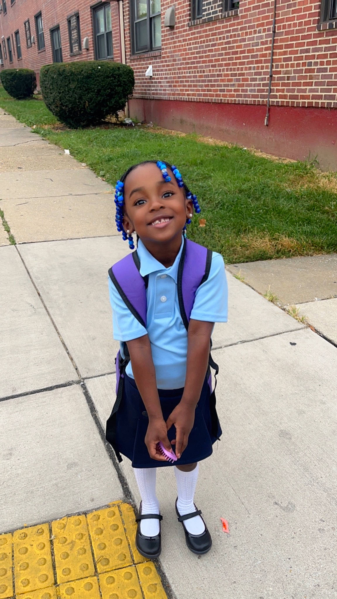 Madisyn is registered to the contest to win money with this photo: asphalt, electric_blue, joy, knee, leg, leisure, pattern, person, pink, plant, recreation, road, road_surface, school_uniform, sidewalk, sleeve, smile, sock, street, t_shirt