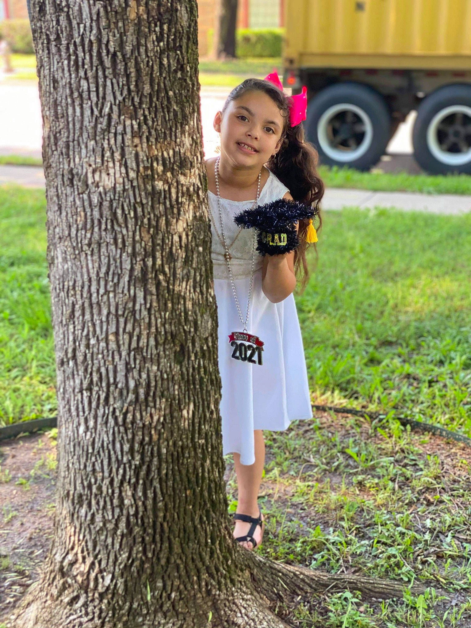 Ariana is registered to the contest to win money with this photo: automotive_tire, botany, day_dress, dress, footwear, grass, happy, hat, joy, leaf, people_in_nature, person, plant, shoe, smile, tire, tree, truck, trunk, waist