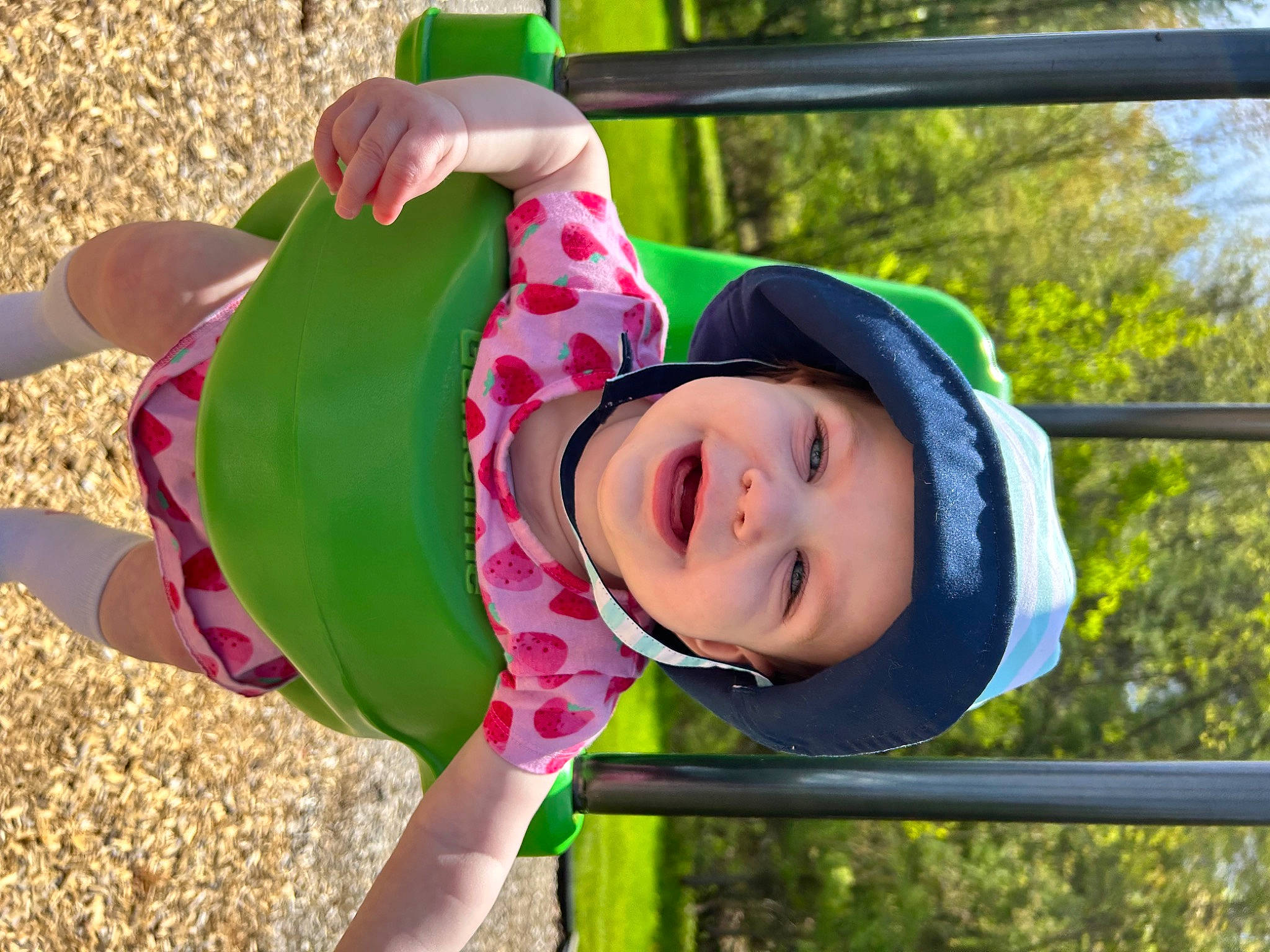 Freyja is registered to the contest to win money with this photo: baby_toddler_clothing, child, city, fun, grass, happy, hat, head, headgear, headwear, leaf, leisure, outdoor_play_equipment, person, pink, plant, playground, recreation, smile, spring