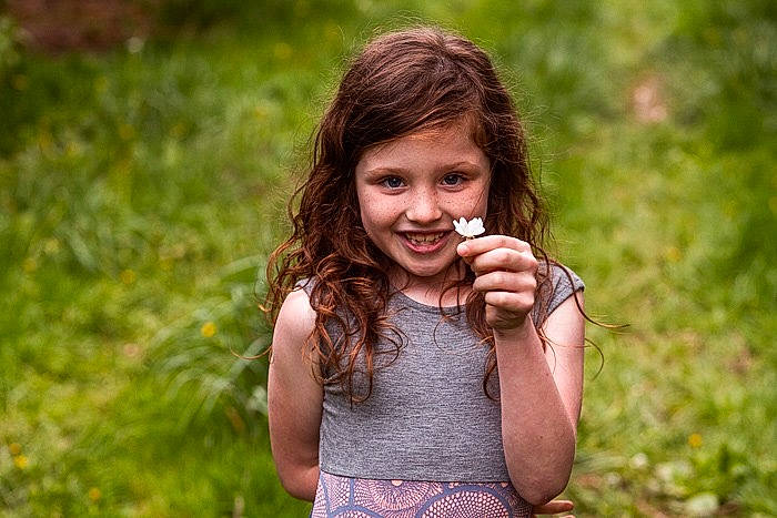 Isabella is registered to the contest to win money with this photo: beauty, brown_hair, child, eye, face, facial_expression, fun, grass, grass_family, green, hair, hand, happy, joy, leaf, long_hair, people_in_nature, person, photography, smile