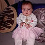 Amalya Jeanvrain a rejoint le concours — aidez-le/la à gagner de superbes lots ! baby, baby_clothes, child, cozy, cushion, cute, donut_pillow, expression, face, home, indoor, infant, pacifier, person, pillow, pink_tutu, portrait, sitting, soft_fabric, white_clothing