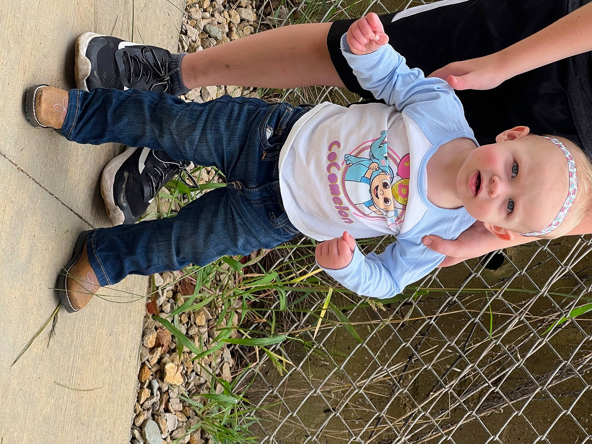 Kynzlee is registered to the contest to win money with this photo: baby, baby_toddler_clothing, child, cool, denim, fence, fun, grass, happy, human_leg, mesh, pattern, people_in_nature, person, plant, sitting, sleeve, sneakers, toddler, tree