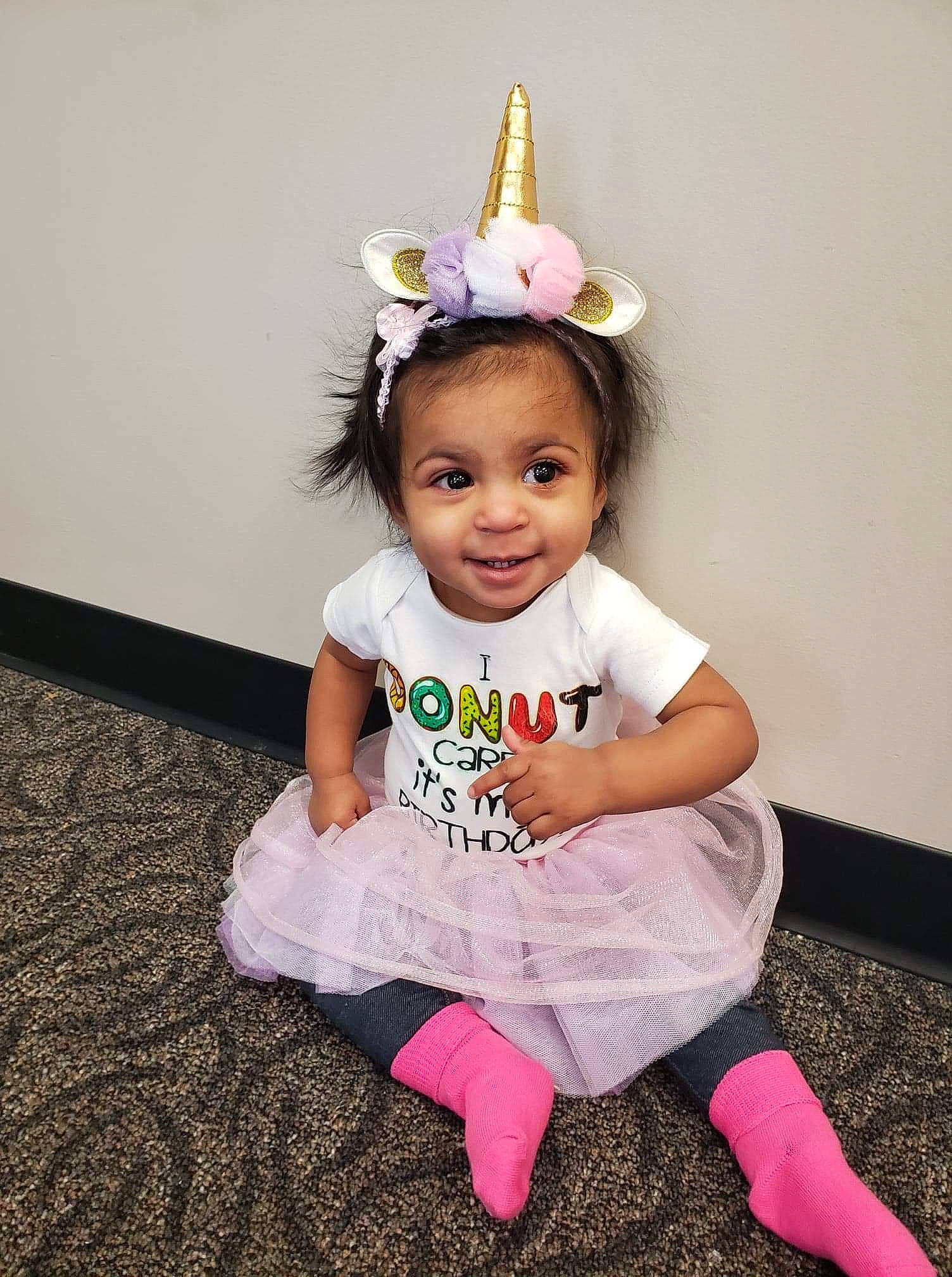 Hailee is registered to the contest to win money with this photo: baby, baby_toddler_clothing, child, costume, costume_accessory, crown, fashion_accessory, hair_accessory, headpiece, joy, party_hat, party_supply, person, pink, sitting, toddler