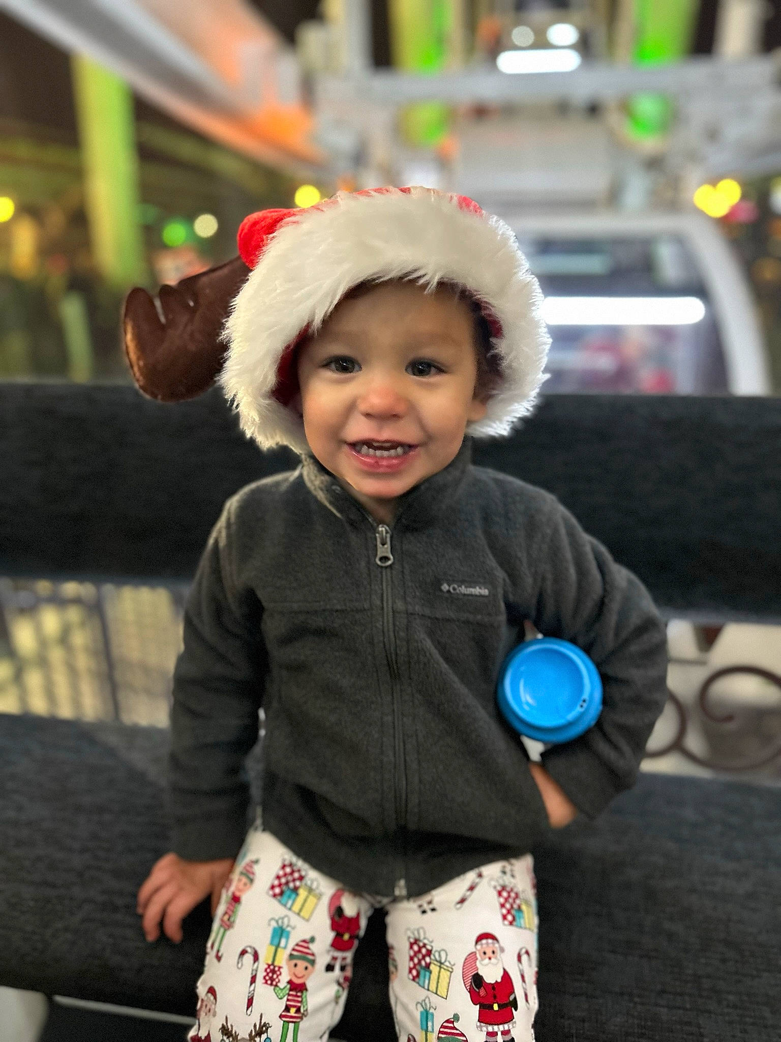 Adarien is registered to the contest to win money with this photo: baby_toddler_clothing, cap, child, facial_expression, fashion_accessory, fun, happy, headwear, human, joy, leisure, pajamas, pattern, person, personal_protective_equipment, recreation, sitting, sleeve, smile, toddler