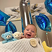 Aslan joined the competition — help win amazing prizes! baby, blanket, stuffed_animal, toy, balloon, blue, silver, celebration, milestone, smiling, infant, star_balloon, number_one_balloon, wooden_badge, cozy, indoor, portrait, happy, cute, decor
