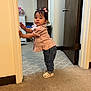 Luna joined the competition — help win amazing prizes! toddler, child, indoor, standing, door_frame, pink_top, denim_jeans, white_sandals, hair_bows, carpet, room, furniture, curious, young_girl, person, casual_clothing, home, door, wall, floor