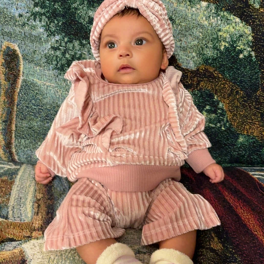 Ansley joined the competition — help win amazing prizes! baby, bonnet, cap, clothing, costume, couch, cushion, face, furniture, hat, head, homedecor, hood, hosiery, pants, person, photography, portrait, sitting, sock