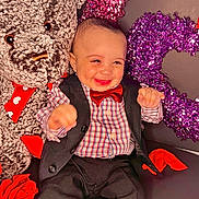 Keziah is registered to the contest to win money with this photo: baby_toddler_clothing, child, christmas, christmas_decoration, christmas_ornament, event, facial_expression, formal_wear, fun, happy, human, leg, magenta, pink, red, sleeve, smile, textile, toddler, tree