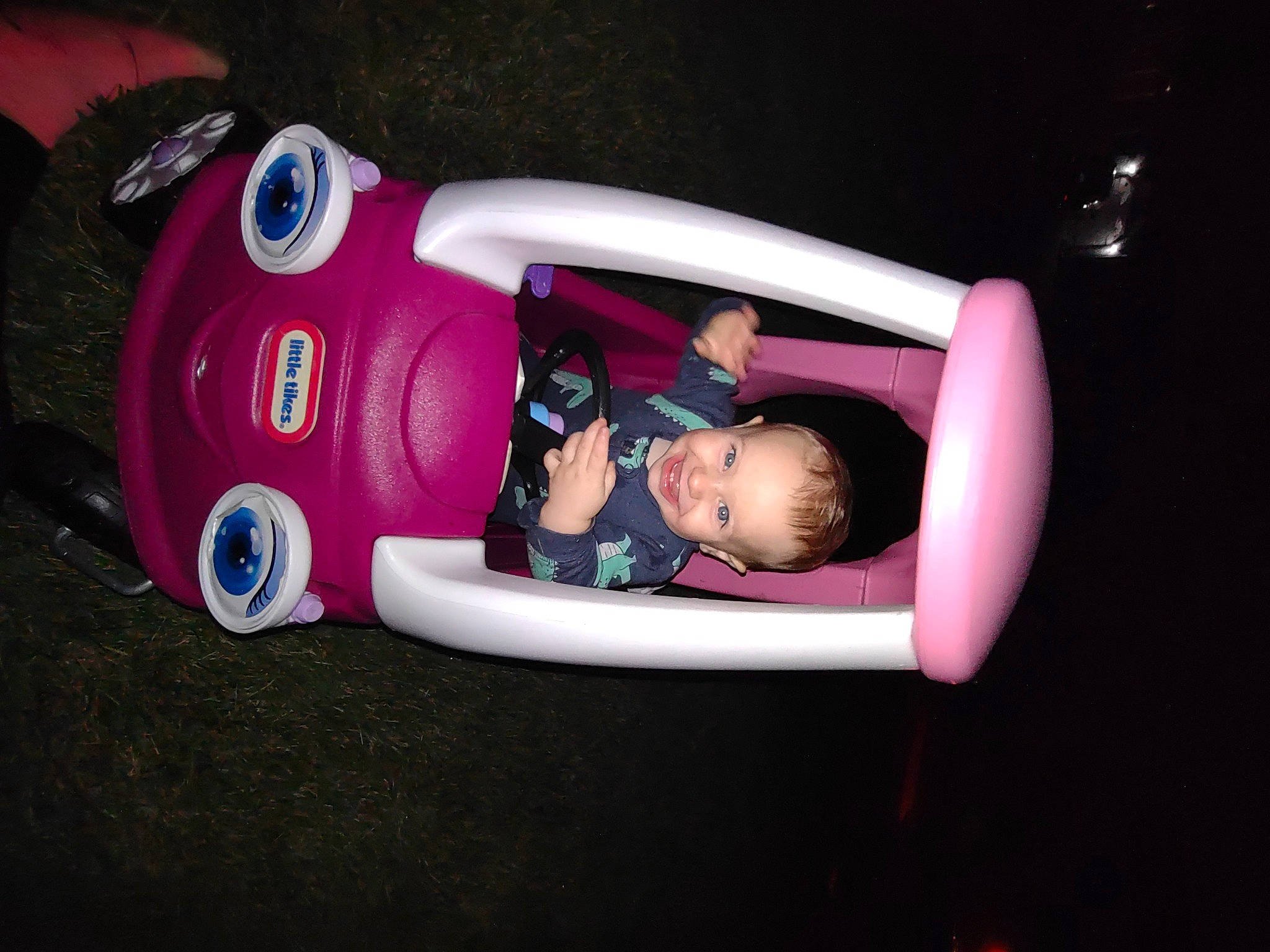 Deacon is registered to the contest to win money with this photo: automotive_design, automotive_exterior, bumper, car, carmine, child, fun, helmet, joy, leisure, luxury_vehicle, magenta, motor_vehicle, person, personal_protective_equipment, recreation, sports_gear, toddler, toy, tree