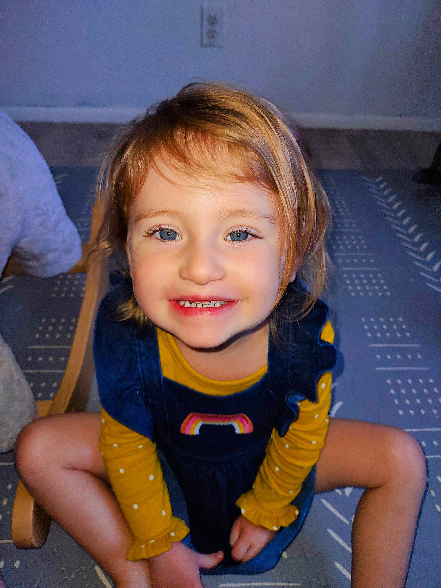 Aubrey is registered to the contest to win money with this photo: baby, baby_toddler_clothing, blond, chair, cheek, child, chin, electric_blue, finger, flooring, fun, happy, iris, joy, mouth, nose, person, sitting, skin, smile