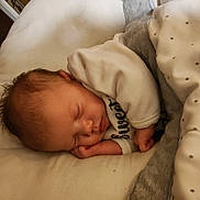 Stormi is registered to the contest to win money with this photo: baby, bed, blanket, child, clothing, cozy, cute, face, hand, indoors, infant, newborn, peaceful, pillow, portrait, rest, sleeping, soft, star_pattern, warm