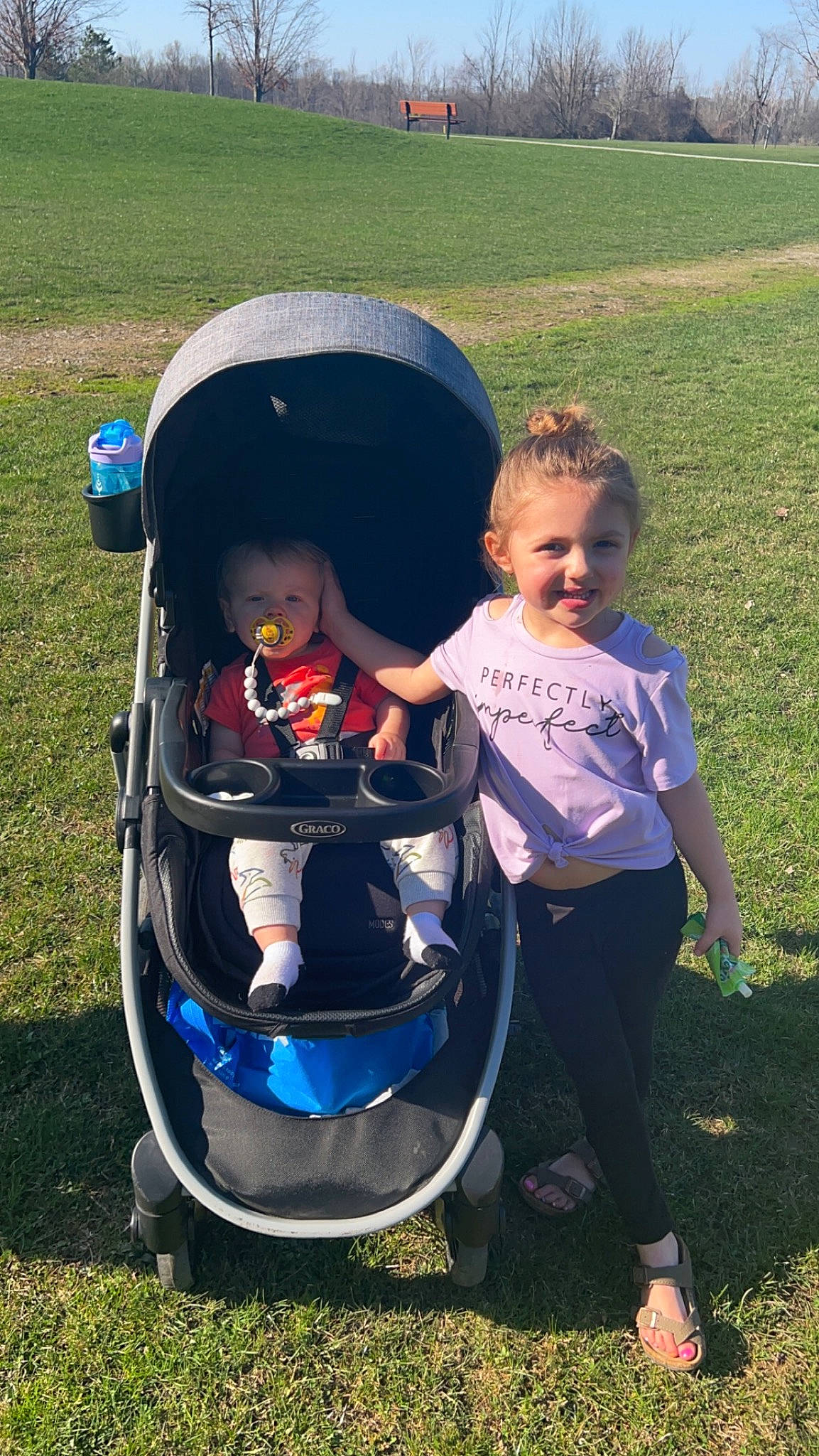 Madelyn is registered to the contest to win money with this photo: auto_part, baby, baby_products, baby_toddler_clothing, child, electric_blue, fun, grass, grassland, happy, hat, joy, lap, lawn, leisure, people_in_nature, person, recreation, sitting, smile