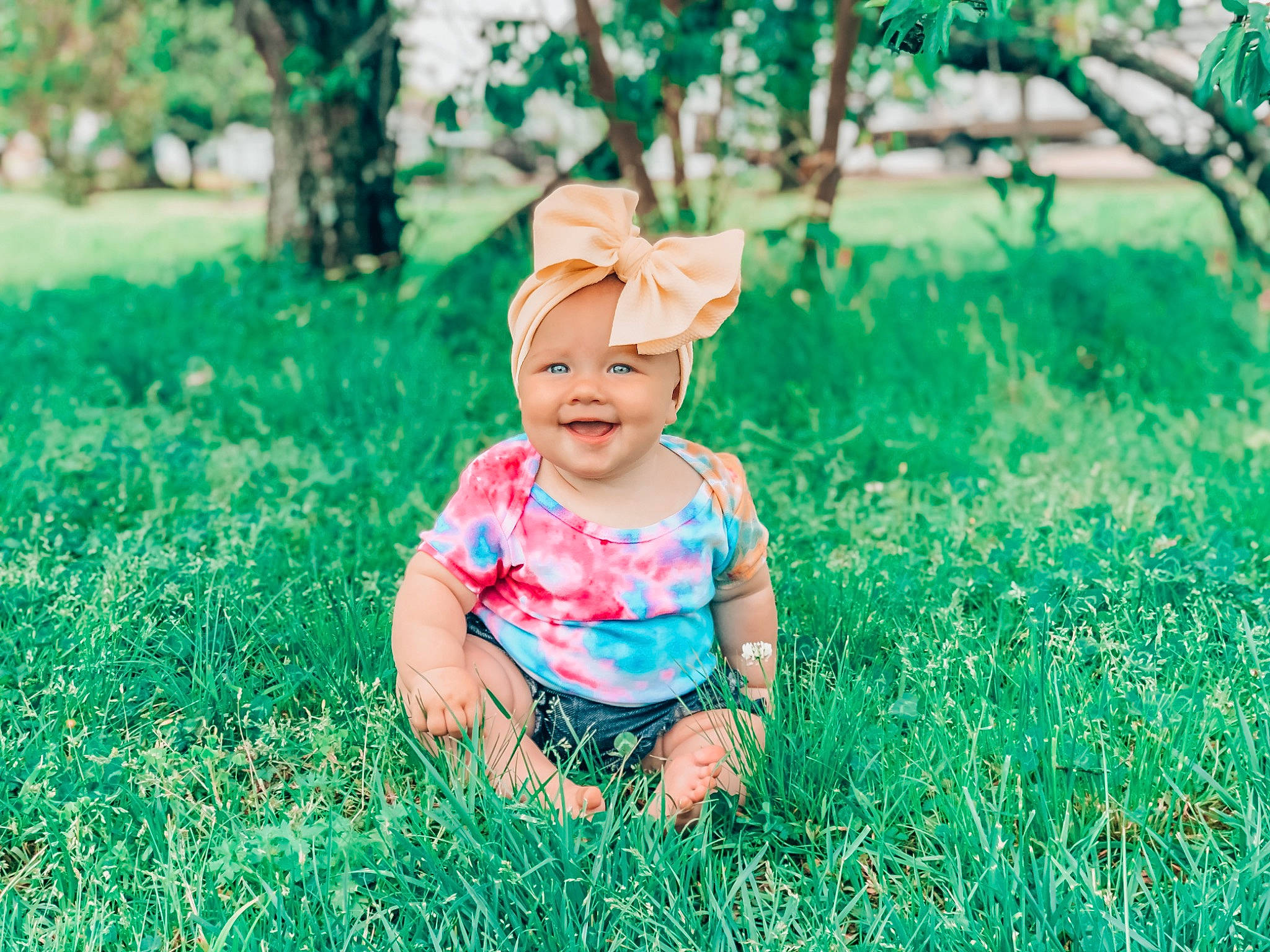 Indie is registered to the contest to win money with this photo: baby, child, grass, grass_family, green, happy, headwear, joy, leaf, people, people_in_nature, person, photograph, photography, pink, plant, portrait_photography, skin, smile, spring