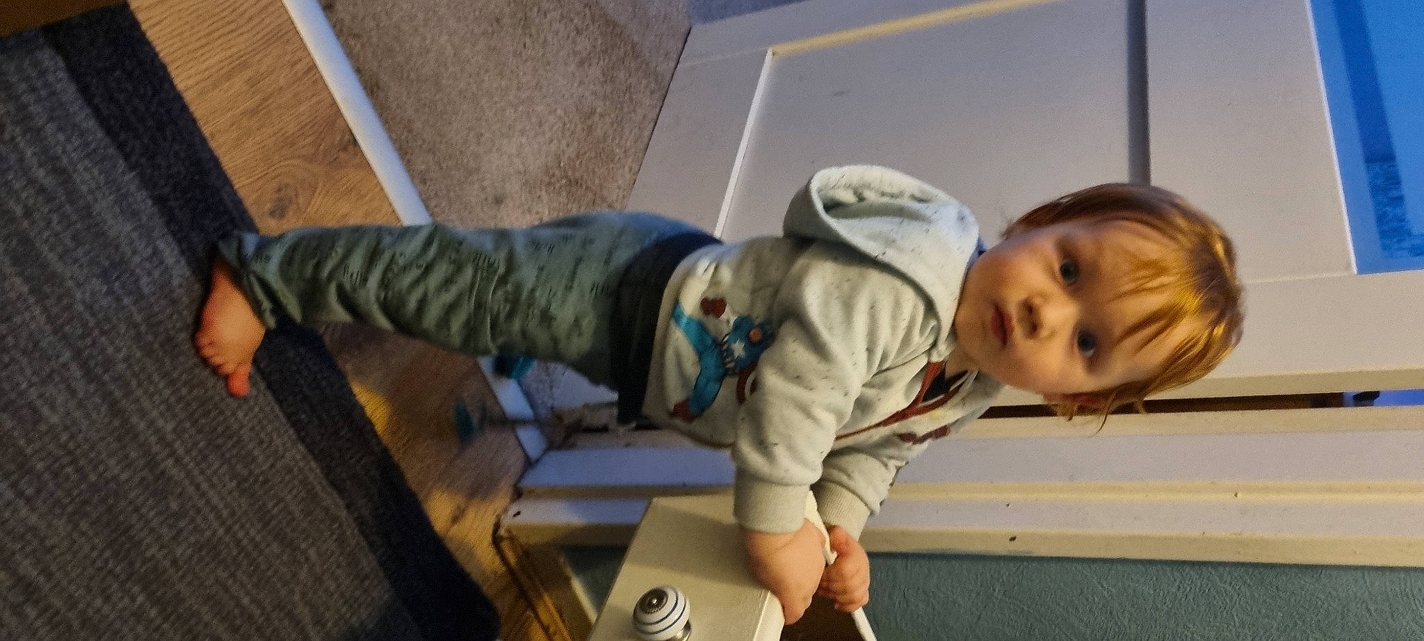 Peter is registered to the contest to win money with this photo: baby, baby_toddler_clothing, child, comfort, elbow, floor, flooring, fun, happy, joint, knee, person, room, sitting, sleeve, toddler, wood