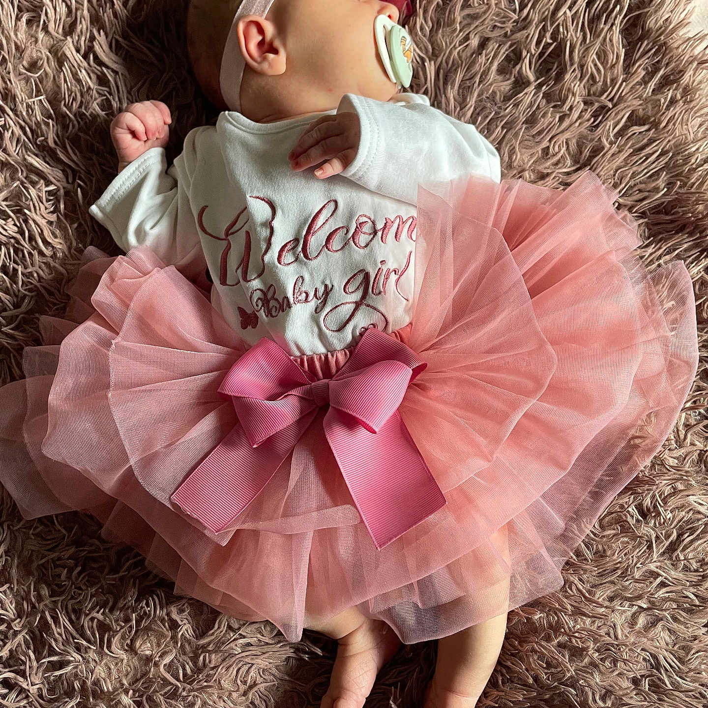 Zhavia is registered to the contest to win money with this photo: adorable, apparel, baby, blanket, child, clothing, cute, girl, headband, infant, laying, newborn, pacifier, peaceful, pink, resting, sleeping, soft, texture, tutu
