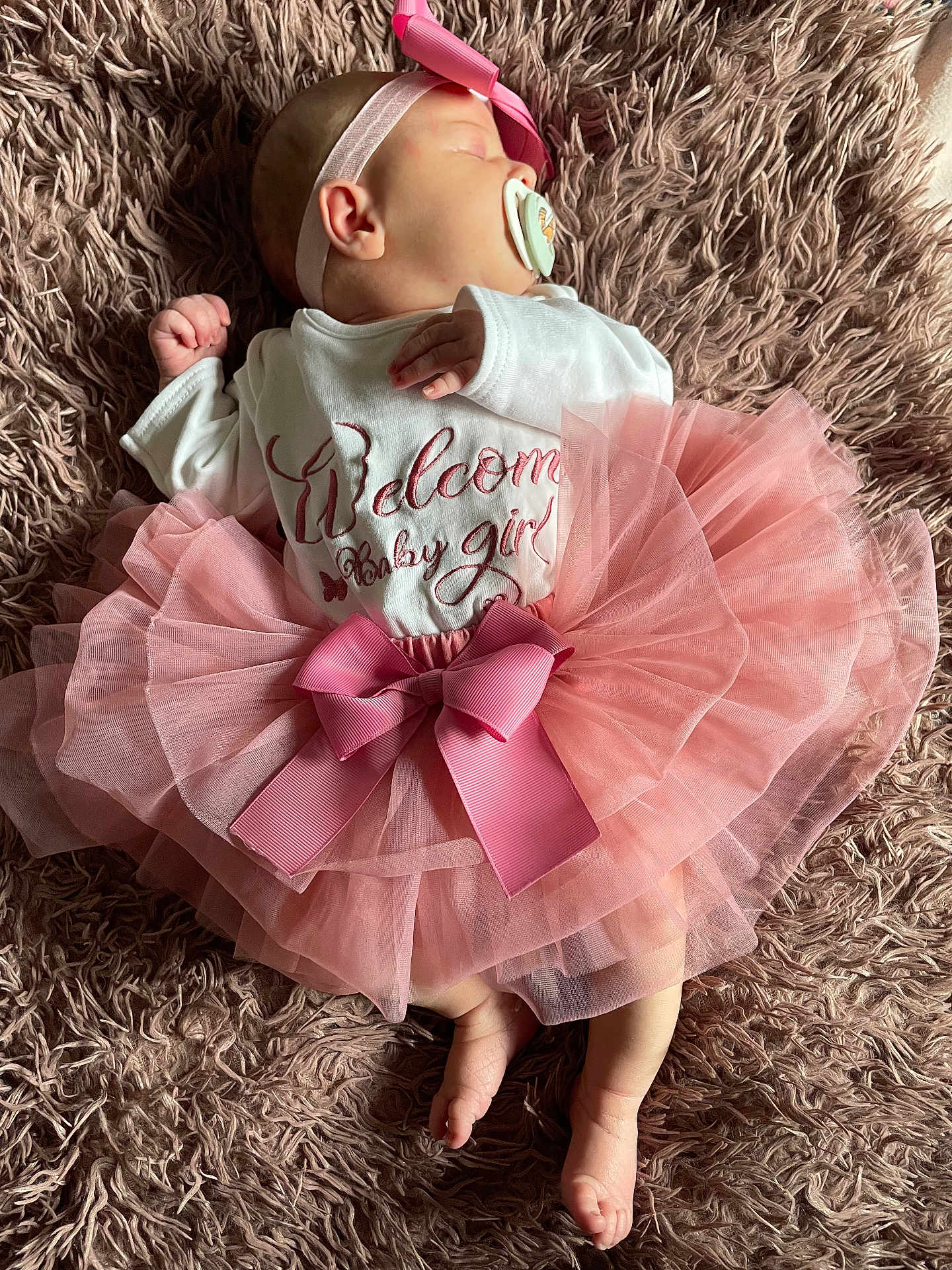Zhavia is registered to the contest to win money with this photo: adorable, apparel, baby, blanket, child, clothing, cute, girl, headband, infant, laying, newborn, pacifier, peaceful, pink, resting, sleeping, soft, texture, tutu