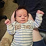 baby, infant, striped_clothing, sleeper, little_brother, hand, person, indoor, carpet, bed, blanket, chair, skin, hair, casual, candid, young_child, holding, comfort, resting