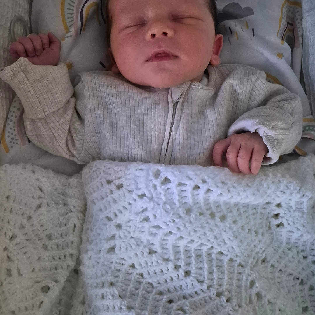 Luca joined the competition — help win amazing prizes! baby, bed, blanket, child, clothing, cozy, crochet, cute, face, hand, indoor, infant, newborn, pattern, peaceful, pillow, rainbow, rest, sleeping, soft