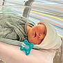 Pierre-Marie participe au concours pour gagner de l'argent avec cette photo : newborn, baby, sleeping, hospital, bassinet, hat, pacifier, onesie, dinosaur_pattern, blanket, infant, cozy, cute, peaceful, child, portrait, resting, soft_lighting, indoor, face