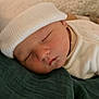 newborn, baby, sleeping, hat, white_clothing, blanket, soft_texture, face, peaceful, infant, cozy, indoors, cute, resting, portrait, child, small, sleep, headwear, warm