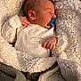 baby, sleeping, pacifier, blanket, soft, cozy, infant, child, white_clothing, wrapped, bedtime, cute, peaceful, indoors, portrait, warm, comfort, newborn, toddler, resting