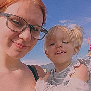 Cecelia is registered to the contest to win money with this photo: woman, child, glasses, smile, outdoor, sky, clouds, mountains, daylight, portrait, happy, casual, person, face, hair, childhood, family, nature, sunlight, selfie